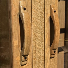 Detail custom hand-made oak & ebony door pulls. Ergonomically designed and crafted with a subtle cove or indentation to the door front to allow for more comfortable room for fingers when opening. 